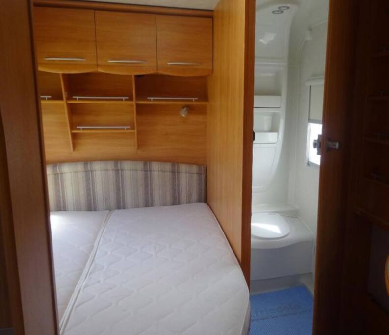 double bed, vanity with large mirror and en-suite shower / toilet.