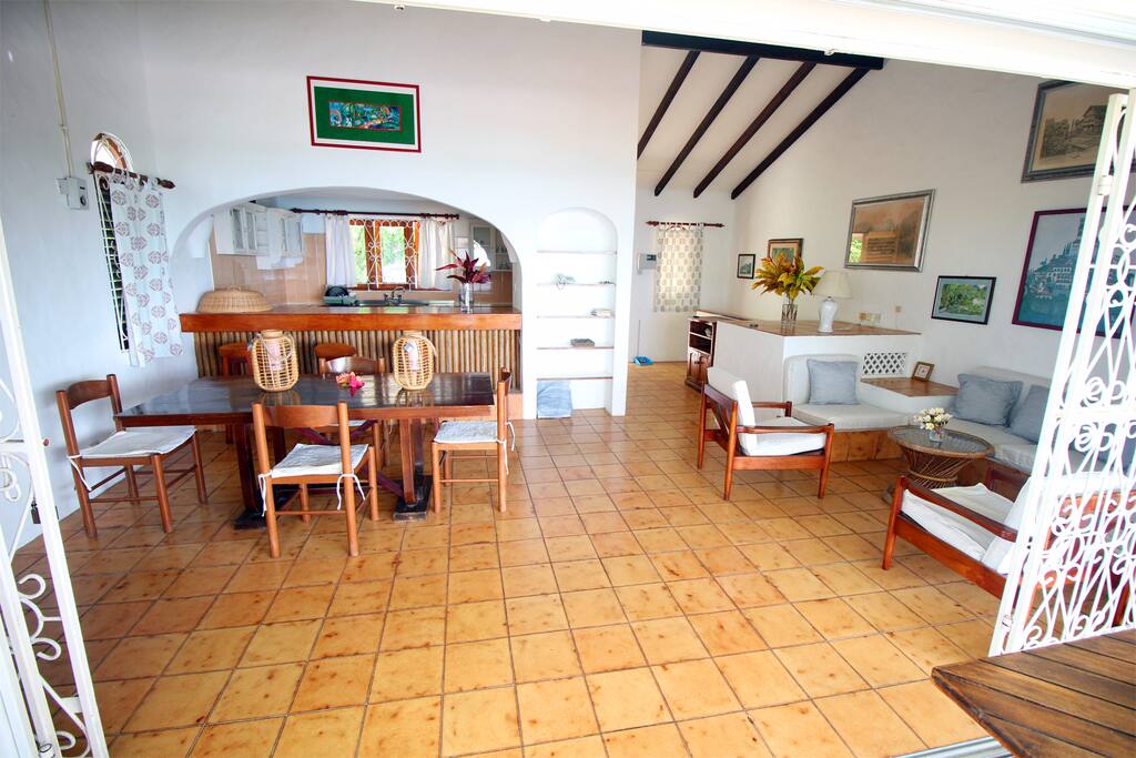 Open living room, dining and balcony overlooking the sea