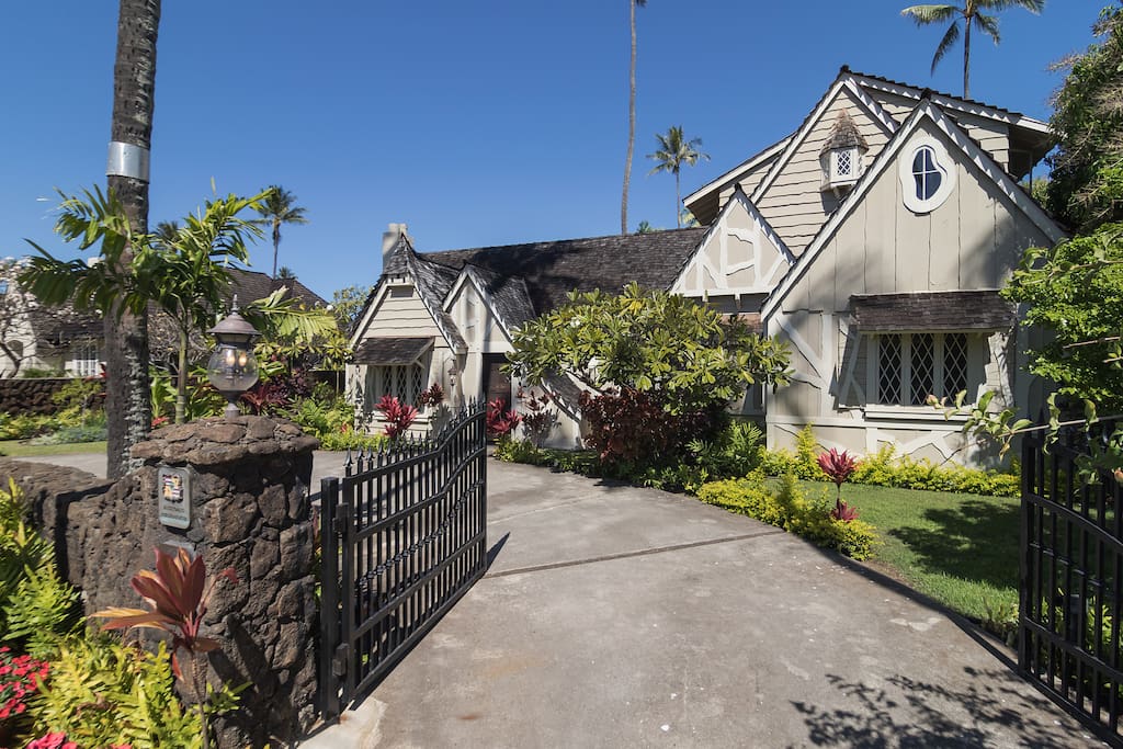 The gates are open welcoming you to the semi circular drive of The Historic Gingerbread House