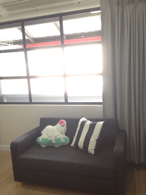 Large window with city view this loveseat sofa can adjust to be an extra ed