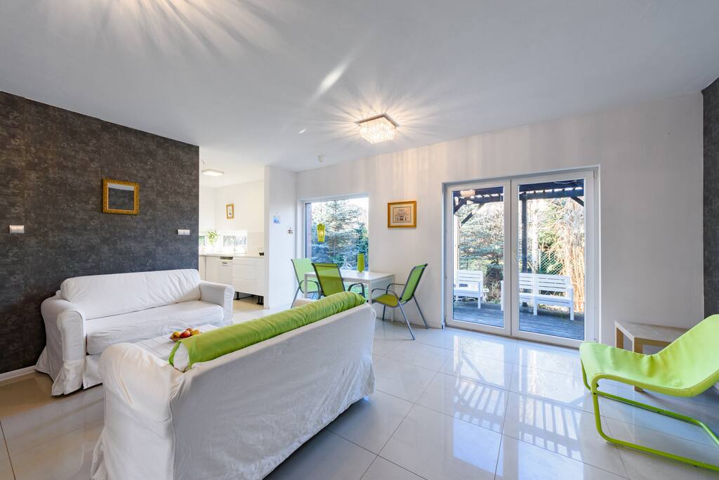 A spacious living room with an entrance to the terrace
