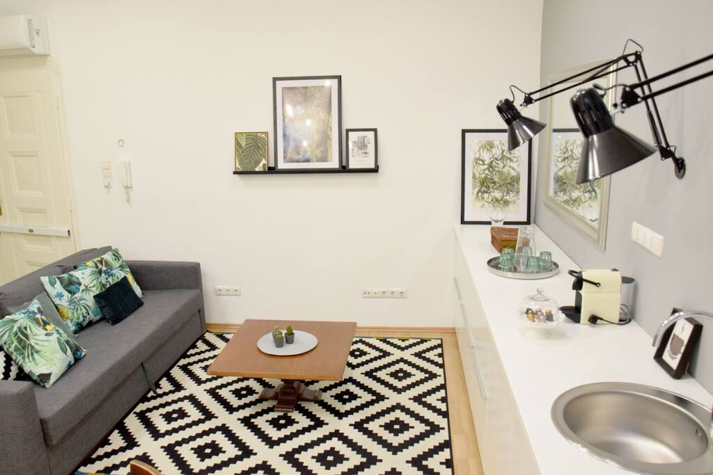 The living room with a spacious & stylish kitchen. Nespresso coffee machine and all kitchenware are provided.