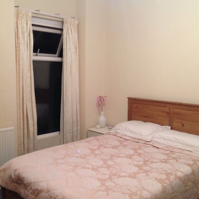 Very Comfy Bed with bedside table and drawer space. Window has view onto Garden.