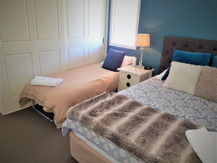 Queen suite with single fold-away made up for a child.