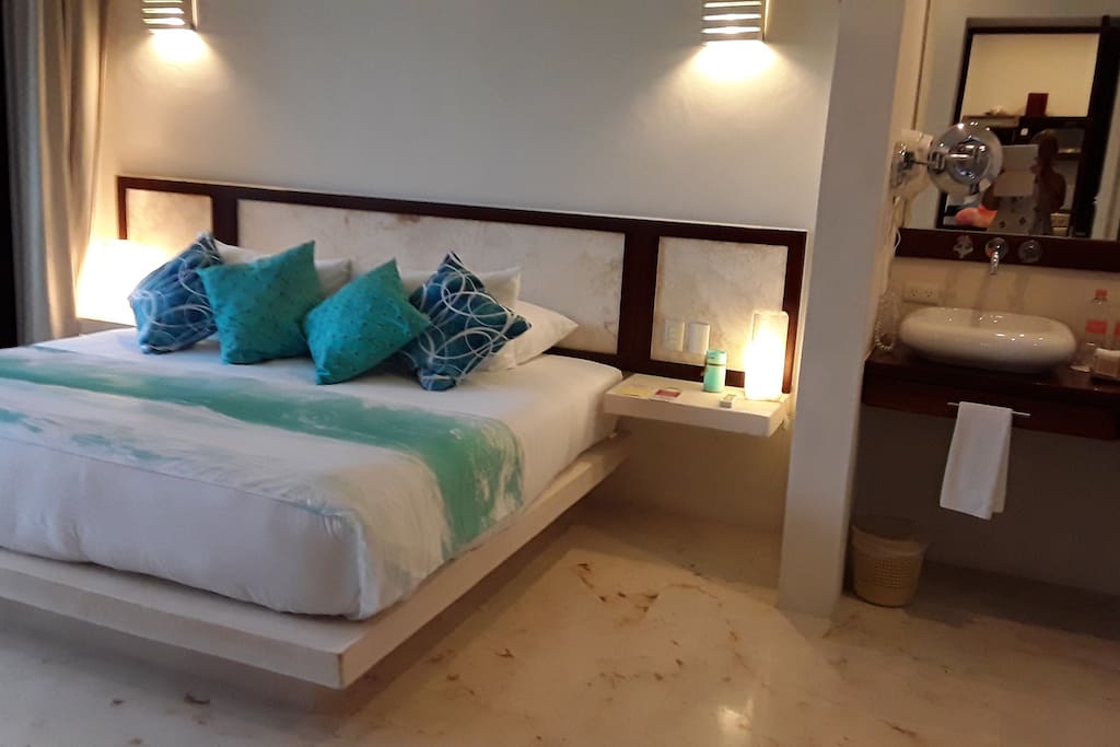 Bedroom with king bed, marble floors