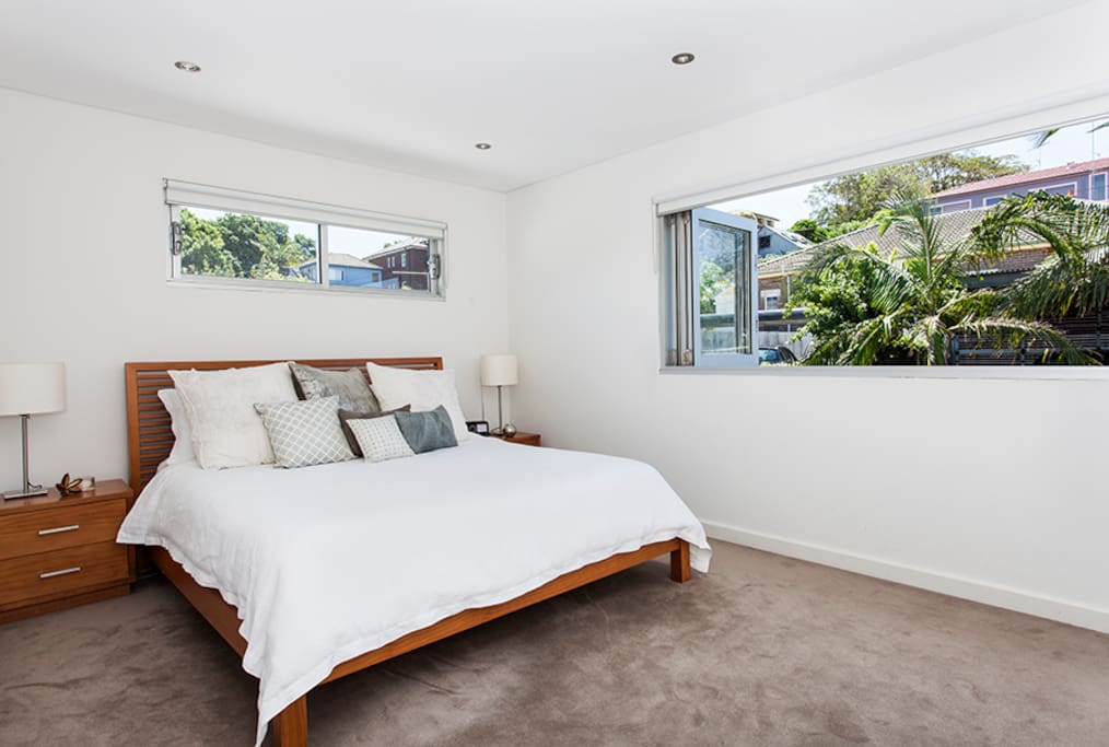Master bedroom (bedroom 1), kingsize bed with bi-fold windows, for cool breezes and fitted wardrobes. Upstairs.