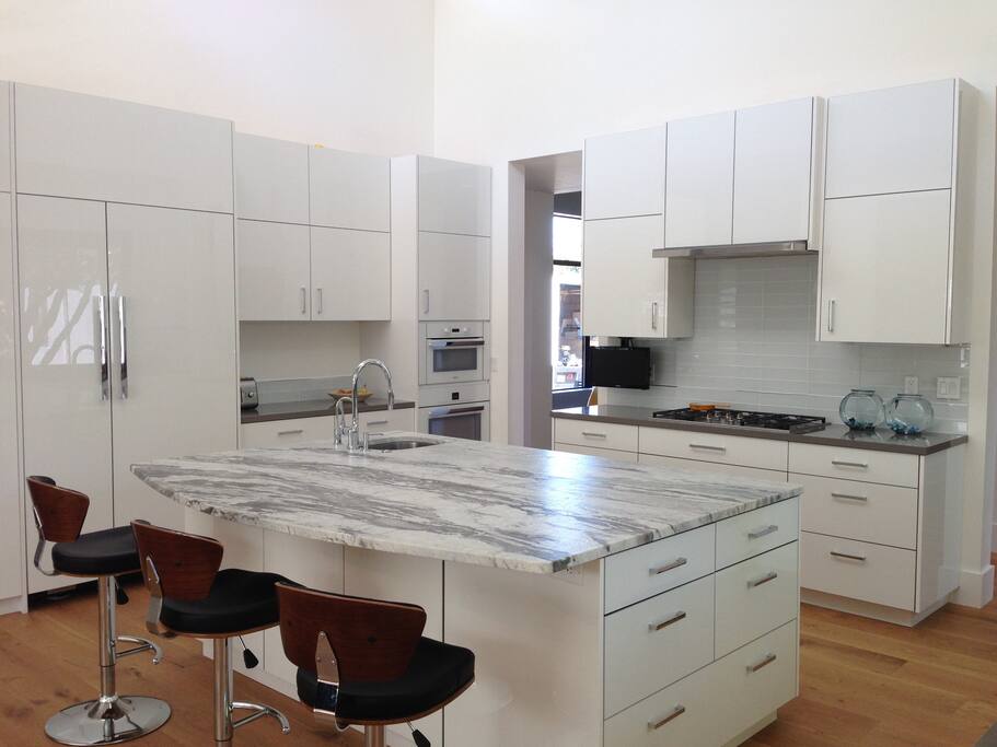 Fully stocked kitchen with gas range and 2 sinks