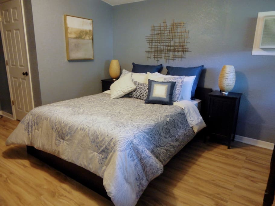 This photo shows the queen-sized bed and the door to the bathroom. We do not keep personal items in the guesthouse so all dressers and nightstands are empty for your use.