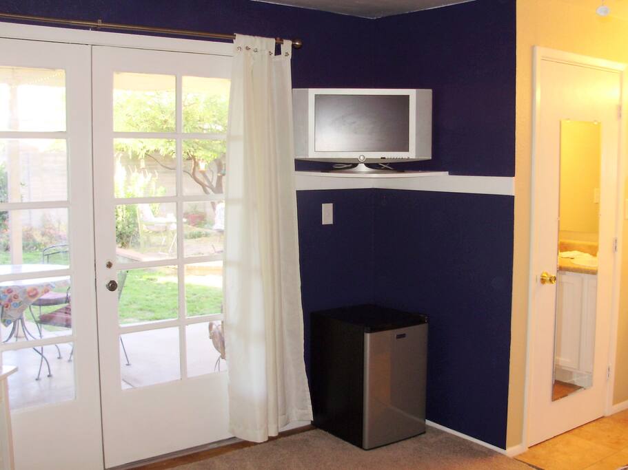 Curtains open, cable TV, mini fridge, microwave oven.