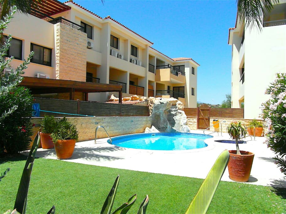 Waterfall, Pool, Jacuzzi & Gardens, with Waterfall running off Apartment Balcony