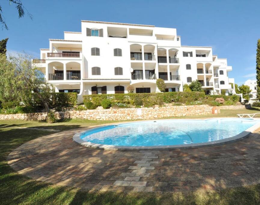 Garden and swimming pool of the condominium .