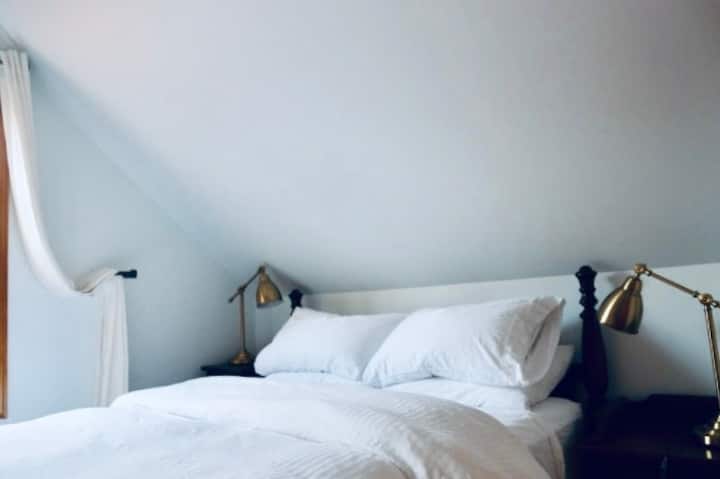 One of four bedrooms, this bedroom is located upstairs and features a Queen sized bed and carved wood furniture.