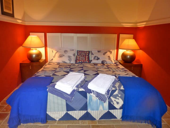 Red bedroom with adjacent bathroom to the left