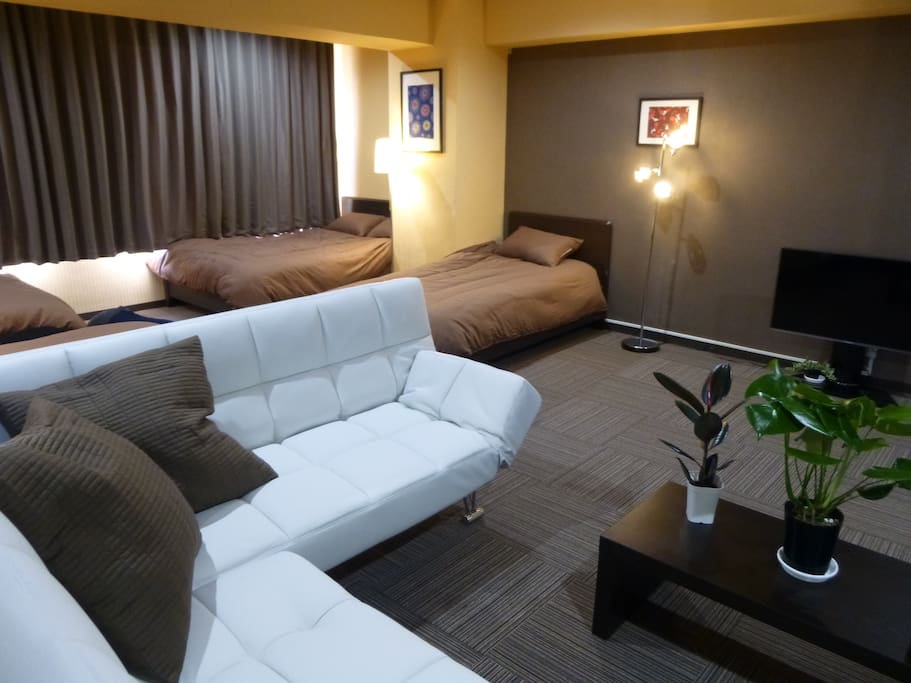 confotable 2 double beds, 2 single beds and 2 sofa beds in a room.