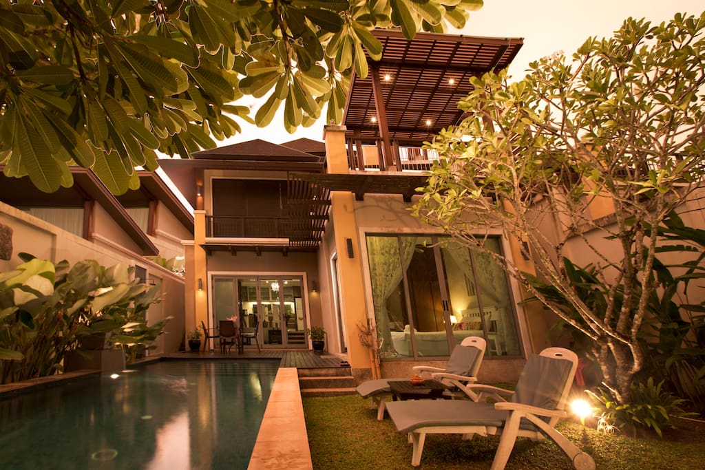 PRIVATE POOL WITH GARDEN AND BACKYARD DURING TWILIGHT