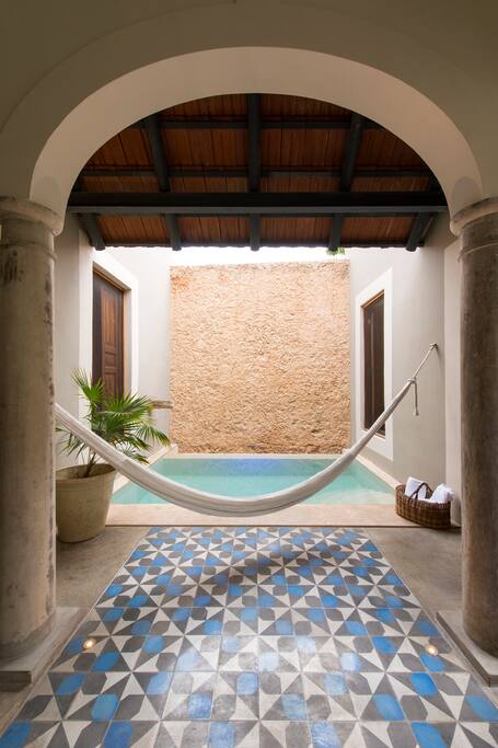 Small pool with relaxing hammock