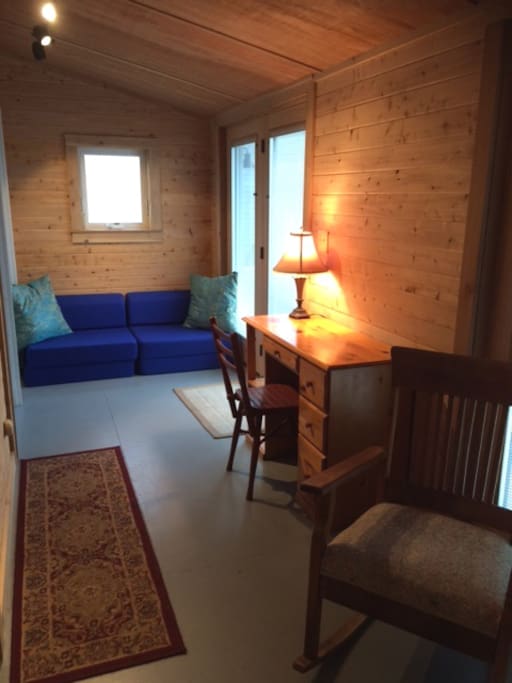 Casual style in the cedar paneled entry. Blue seats fold out for sleeping.