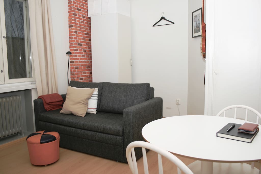 Quiet one-room studio with a quality sofa bed and space to eat and work.