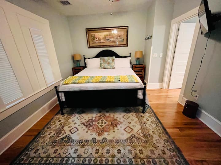 King master bedroom with double door access to back porch and hot tub.