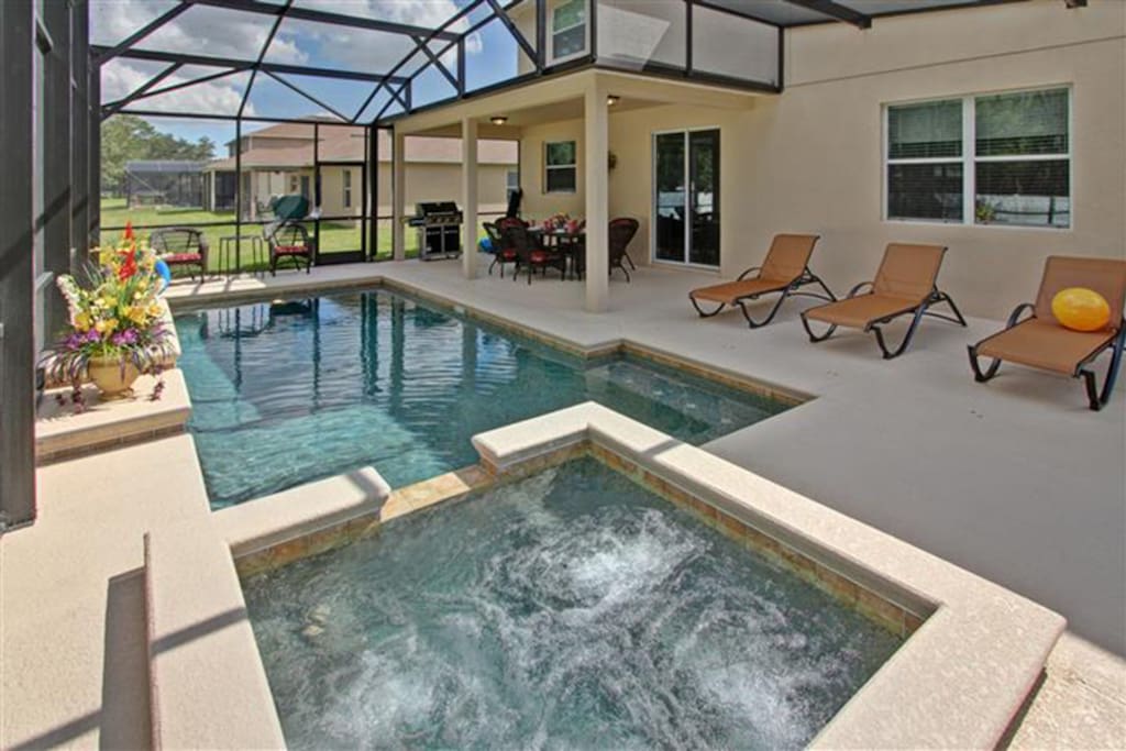Screened back yard with Heated Pool and Spa and BBQ