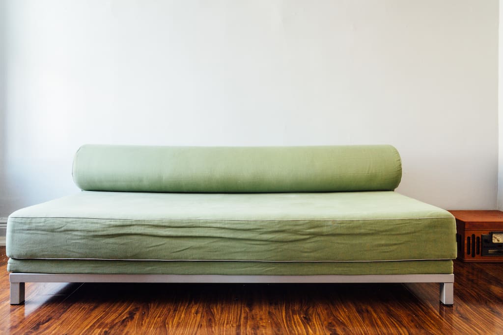 The bed in this room is a very comfortable sofa bed that was recently purchased.