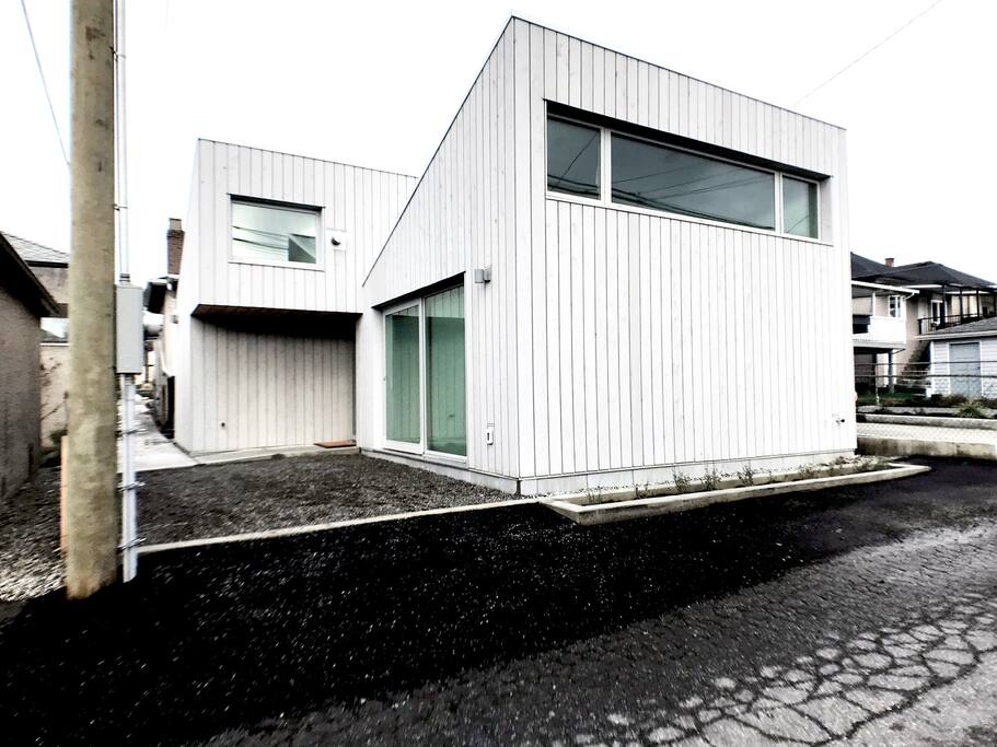 Exterior View. Parking Pad, entrance and clerestory windows.