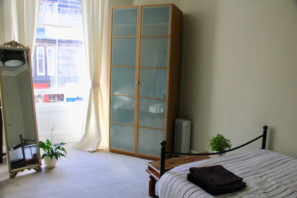 Bright bay windows and storage space in double bedroom