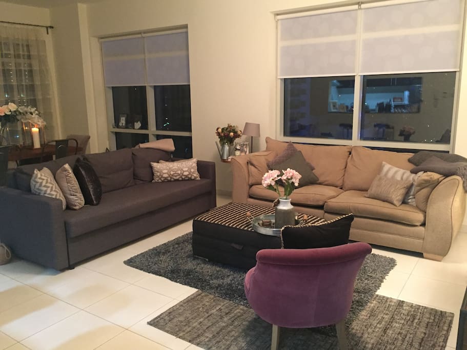 Bright lounge/dining room with comfy sofa's (one sofa bed) and TV. Floor to ceiling windows overlooking the Marina.
