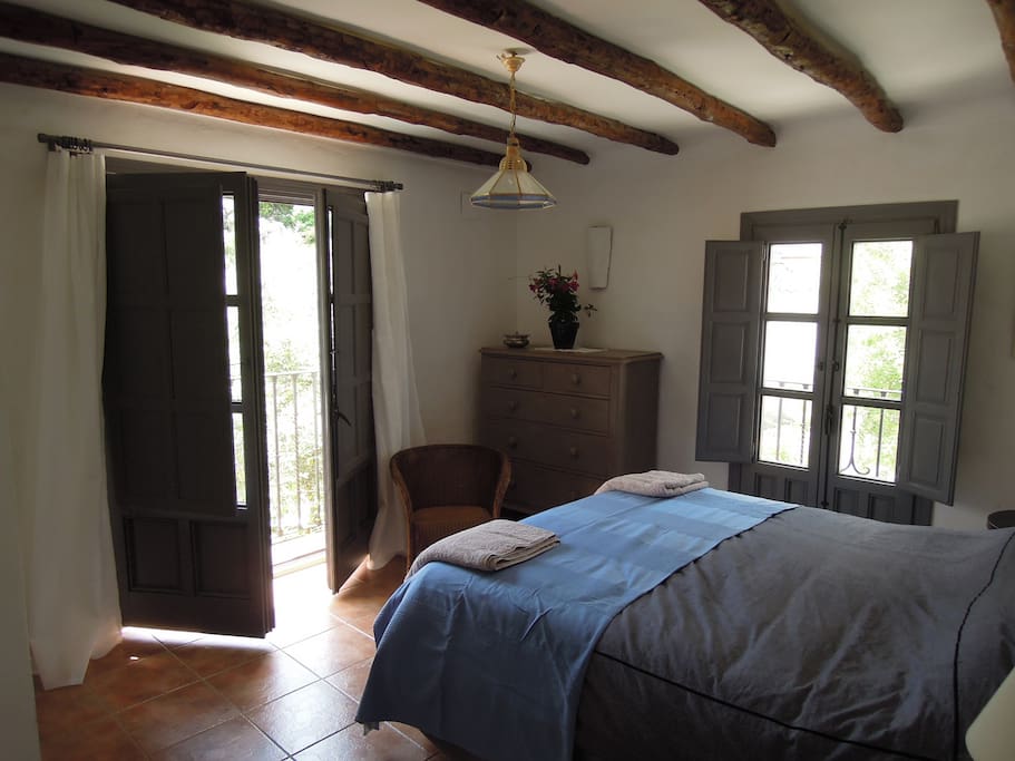 Main bedroom with French doors onto balcony .