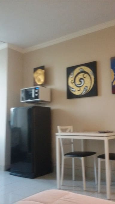 refrigerator and microwave next to kitchen table
