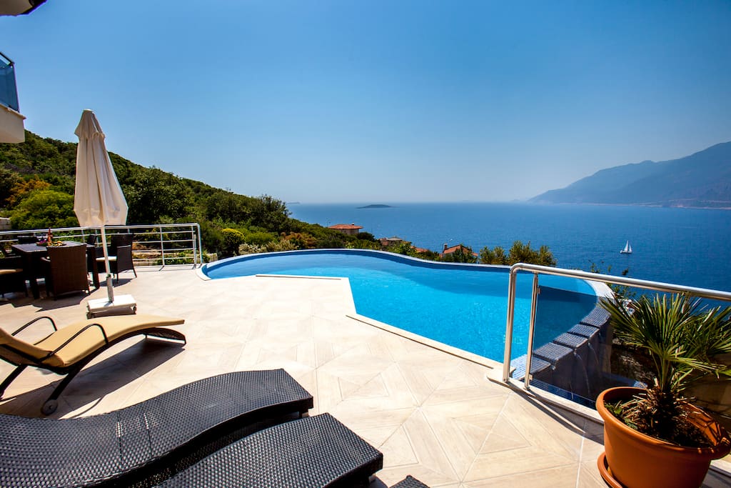 Terrace with 6 sunbeds and sun ambrilla and table with chairs for 8 people.