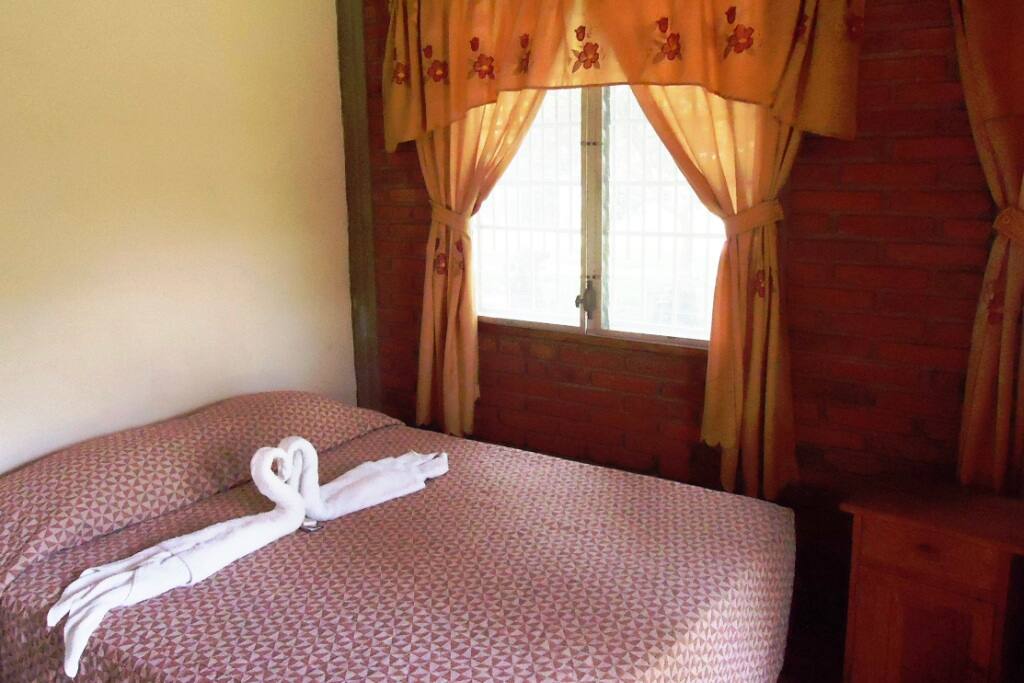 Double sized bed in family room.
