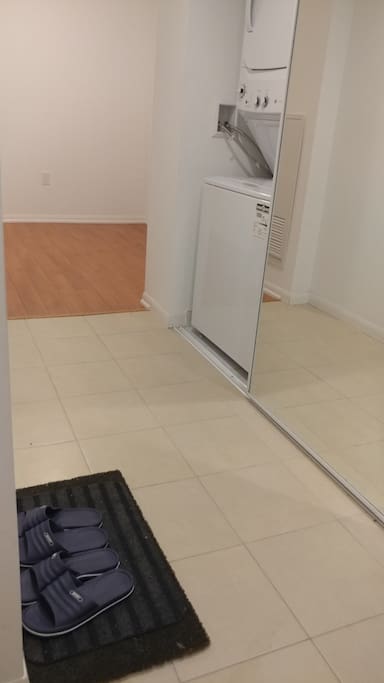 Washer, dryer and den to the right of the main entrance