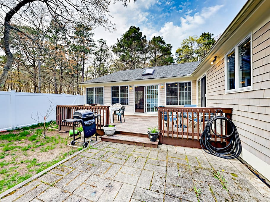 French doors open out to a fenced backyard and deck.