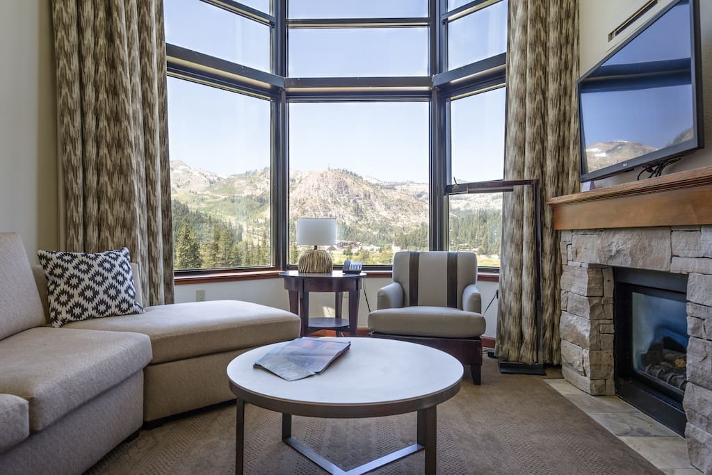 Living room featuring a gas fireplace with breathtaking views. The couch turns into additional sleeping space for two.