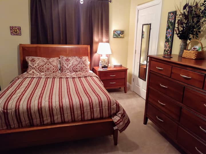 The Gold Room features a new Queen Size mattress, bedding, original and eclectic art on all the walls.