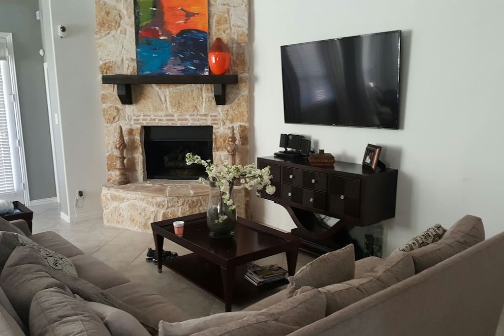 Spacious living room worth 65 inch TV and fire place.
