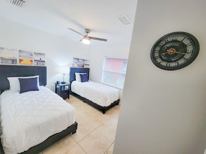 ينتظرك سريران مزدوجان مريحان، مع مروحة سقف لخلق بيئة نوم مثالية.  توفر غرفة النوم هذه أيضًا خزانة ملابس وخزانة ملابس كبيرة (غير مصورة)