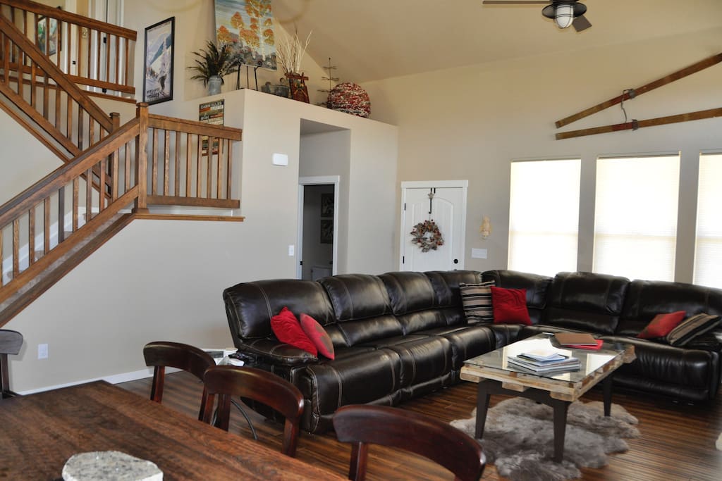 Main floor living area with large reclining leather sofa, Cable TV, DVD player