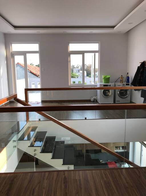Open laundry area with drier, washer
