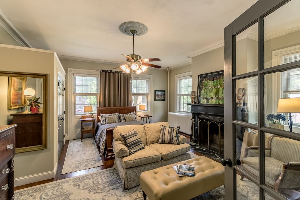 Front bedroom with private sitting area and queen-sized bed.