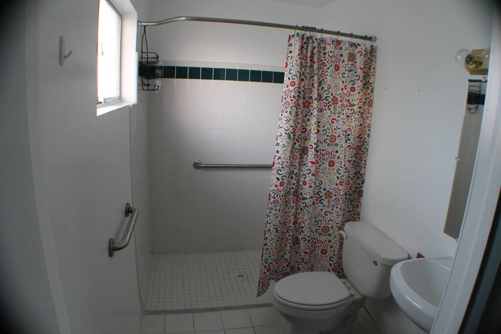 Bathroom attached to room with walk in shower.