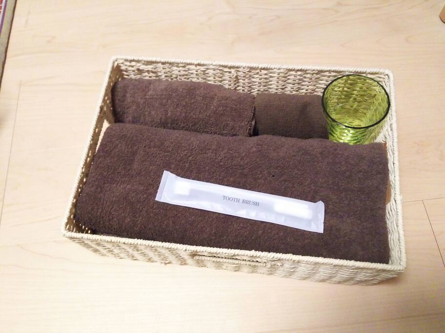 Bath towel, face towels, cup, toothbrush and toothpaste for guests.