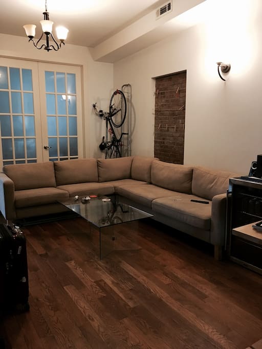 Large shared living room with high ceilings and cozy couch