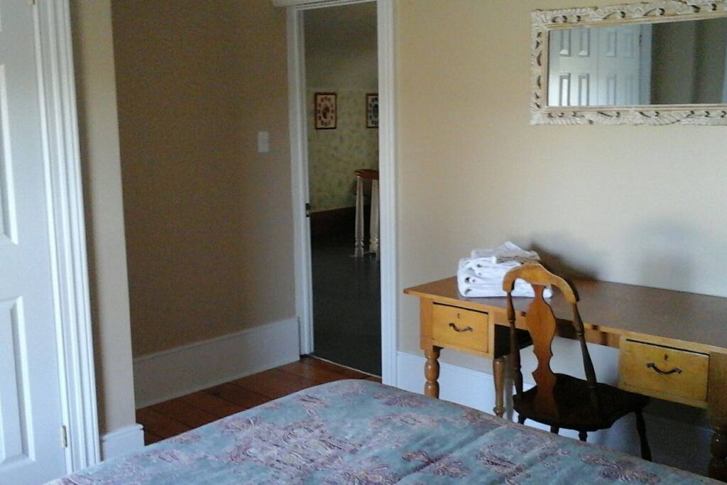 Desk, dresser and full size closet in bedroom