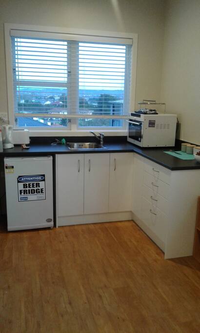 Kitchen with fridge microwave and little oven