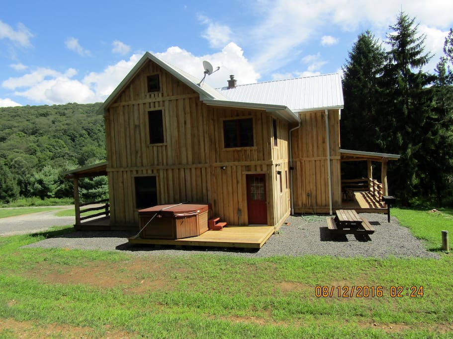 Back of house with picnic area and hot tub