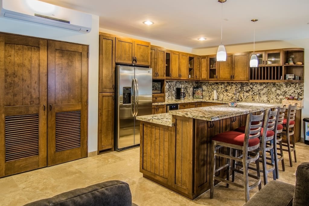 Fully equipped modern kitchen including wine cooler, dishwasher, coffee maker, and gas stove
