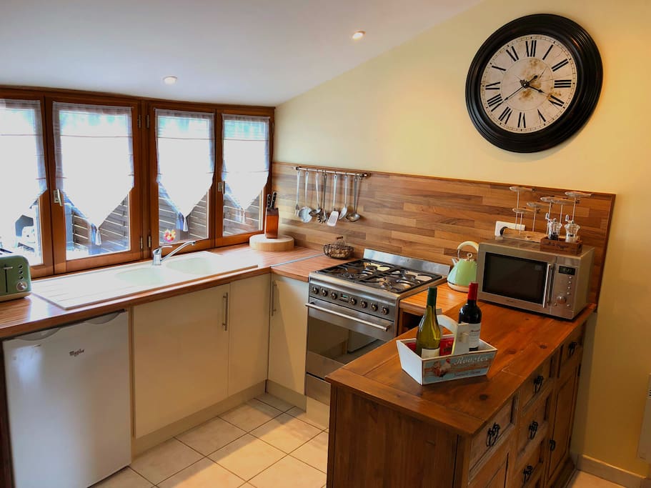 Kitchen area equipped with modern appliances and utensils