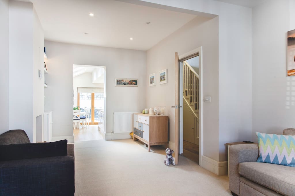 Cosy double living room leading into kitchen area.